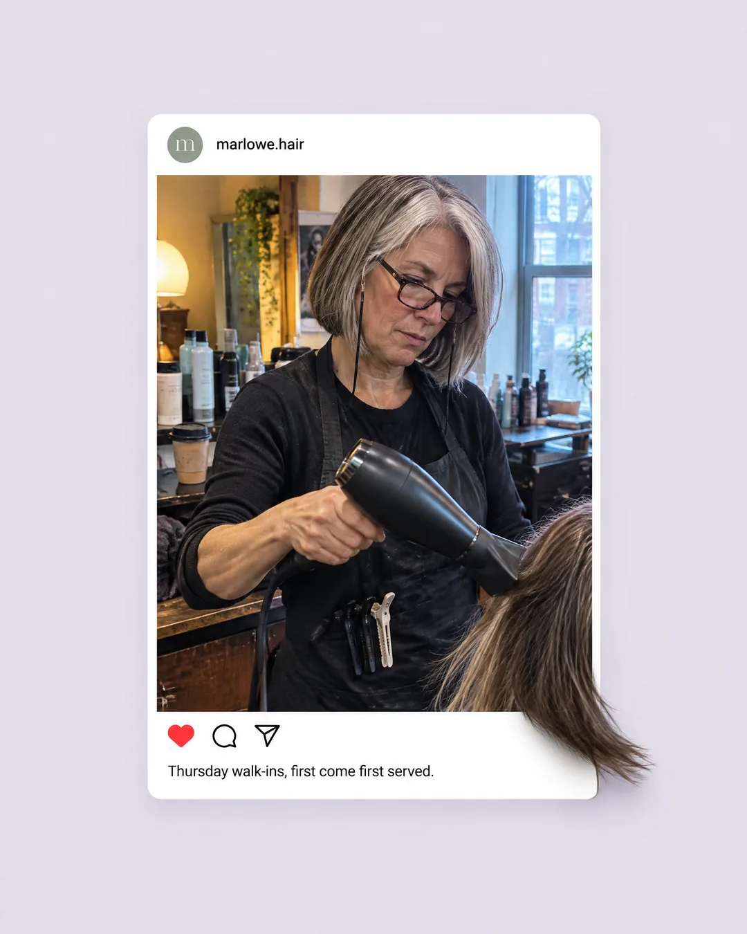 Marlowe Hair, Instagram post: a stylist in her fifties blow-dries a client's hair, the dryer and a lock of hair reaching past the post frame